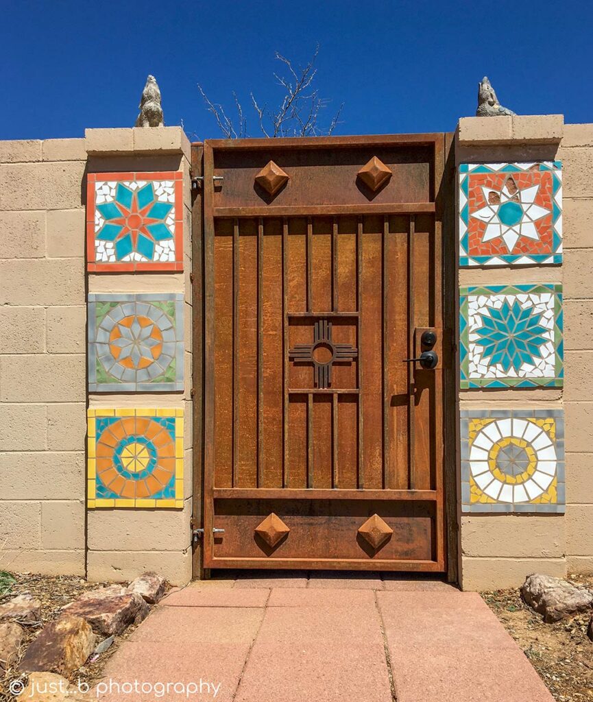 Metal door with Zia sun symbol and colorful tiles