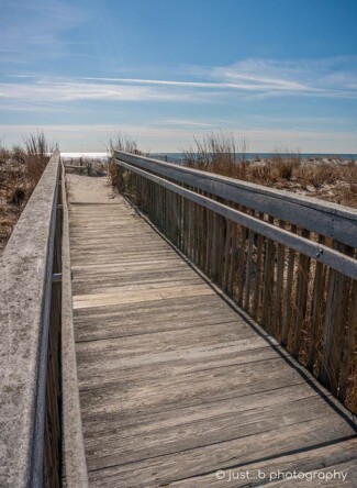 Wooden pathway leading down to beach on a cold winter day.