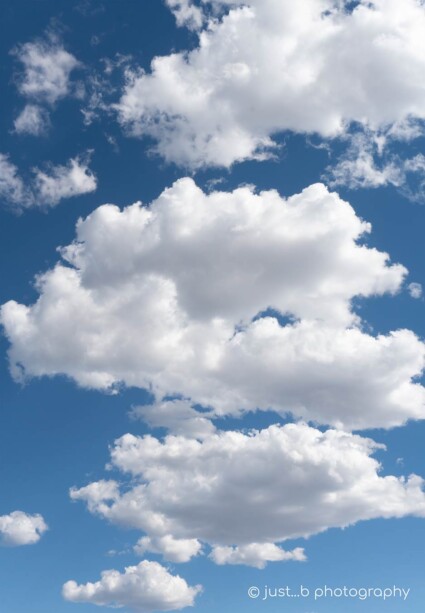 Big white fluffy clouds against blue sky in New Mexico.