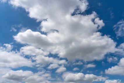 White billowy clouds against bright blue sky