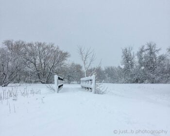 Snow covered footbridge during snow storm.